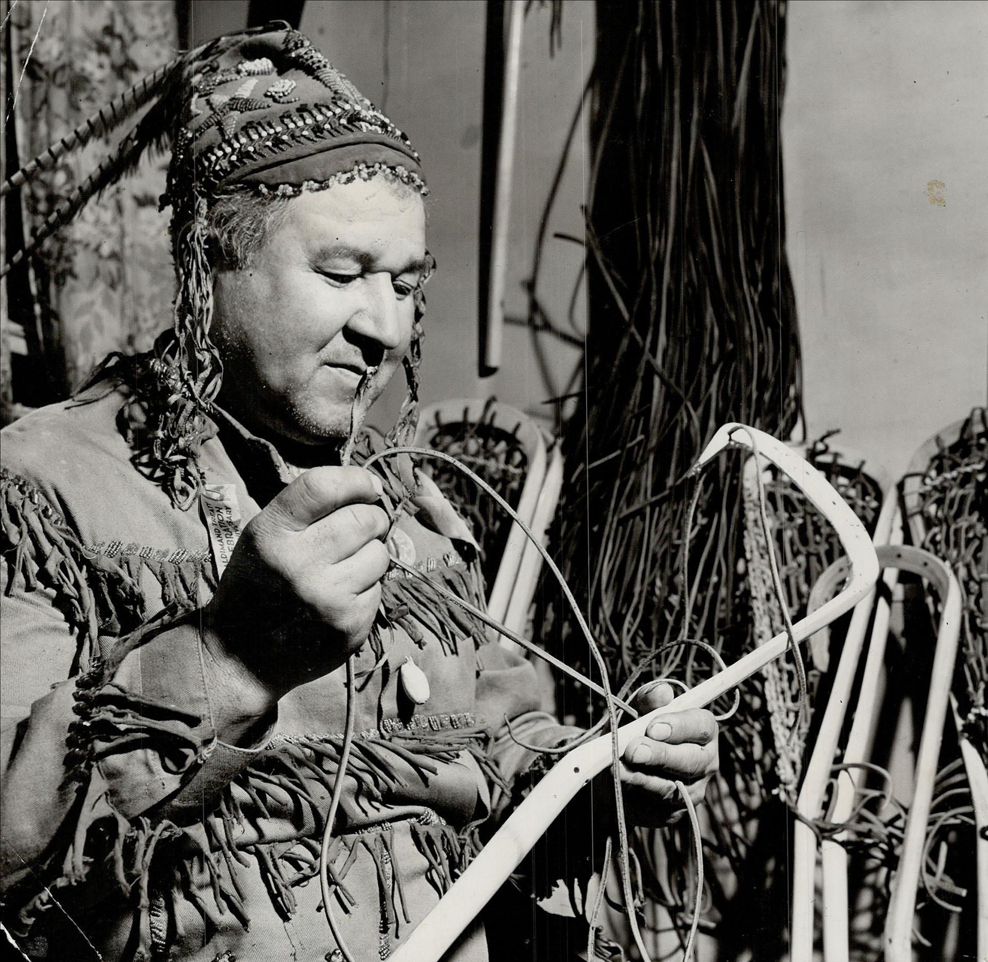 A photograph from the Toronto Star with the original caption: "The Mohawk; one of the brilliant lacrosse-playing Martins; scalped a good many palefaces in his active playing days. Now on the Brantford reserve; he makes the best lacrosse sticks in all Canada and as a result the world beats a path to his door. He has a big export market." Image by Harold Barkley and sourced from the Toronto Public Library.