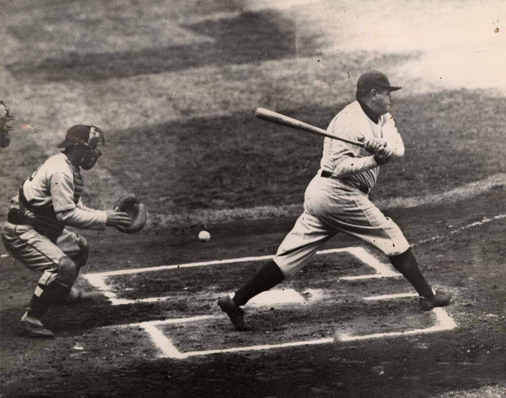 A photograph featured in the Toronto Star titled "Babe Ruth batting in an exhibition game between the Yankees and the Brooklyn Dodgers," published in April 1934. Sourced from Newspapers.com.