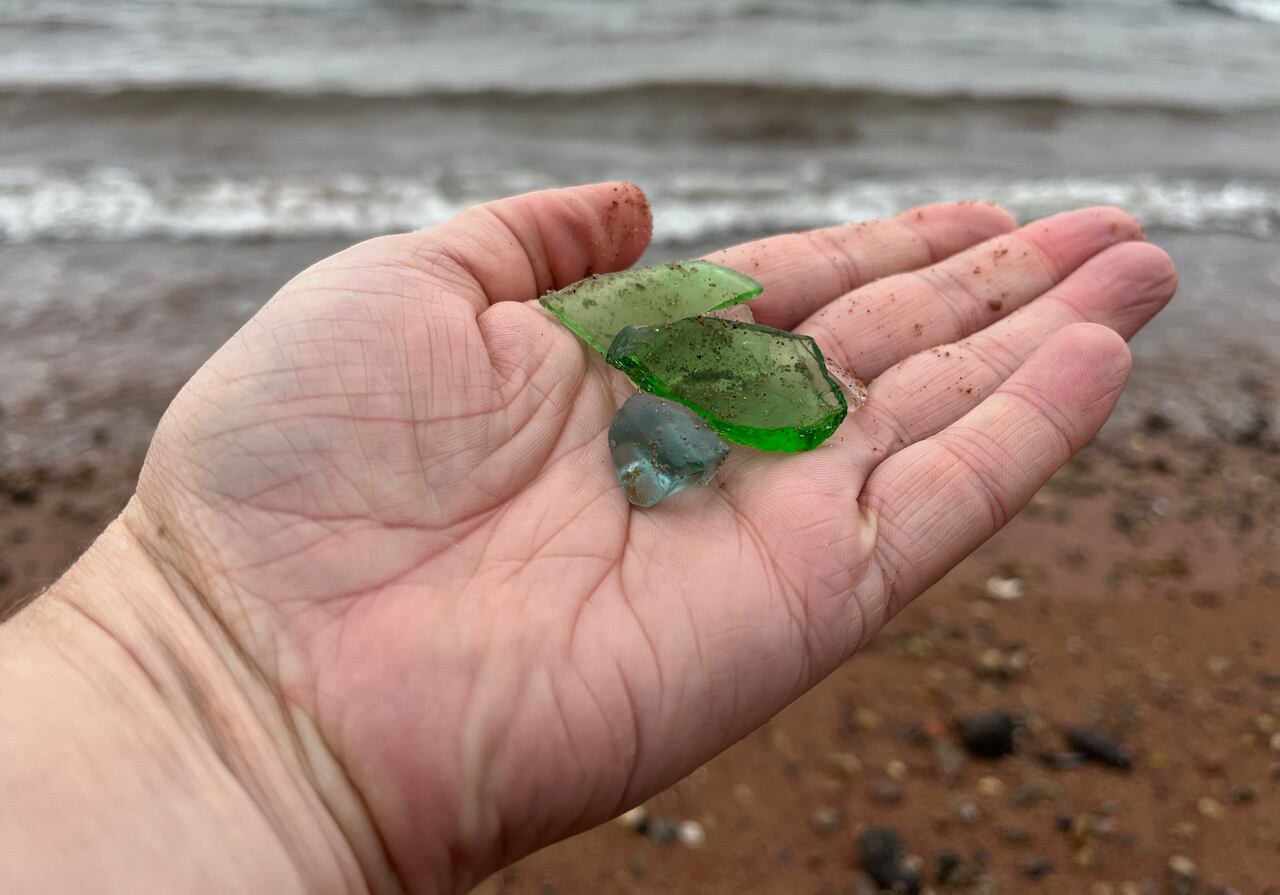 After a glass item is discarded in the sea and shatters, it can take many years for the shards to become opaque and the edges to smooth out from being tossed around in the water and sand by the force of waves and tides. Image by Jane Robertson and sourced from the CBC.