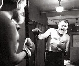 A photograph of Ernest Hemingway shadow-boxing in the mirror. Image sourced from Peter Chrisp blog.