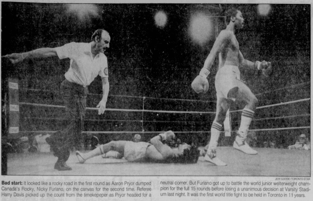 A photograph of Nicky Furlano on the mat after been knocked down by Aaron Pryor, after which Nicky Furlano would get up to rejoin the fight. The picture was published by The Toronto Star on June 23, 1984. Image taken by Jeff Goode and sourced from Newspapers.com.