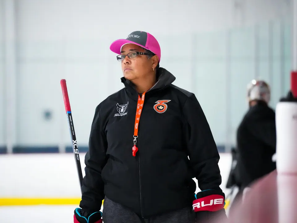 A photograph of Toronto Six coach and former Olympiad hockey player, Angela James, coaching the Toronto Six in 2021. Image captured by Nathan Fernandes and sourced from Forbes.