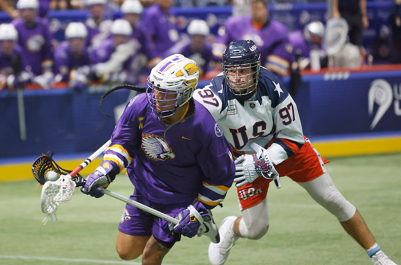 A photograph of Haundenosaunee lacrosse player Lyle Thompson outmaneuvering Team USA defender John Wagner during a game on September 27, 2024. Image taken by Scott Schild and sourced from Syracuse.com.