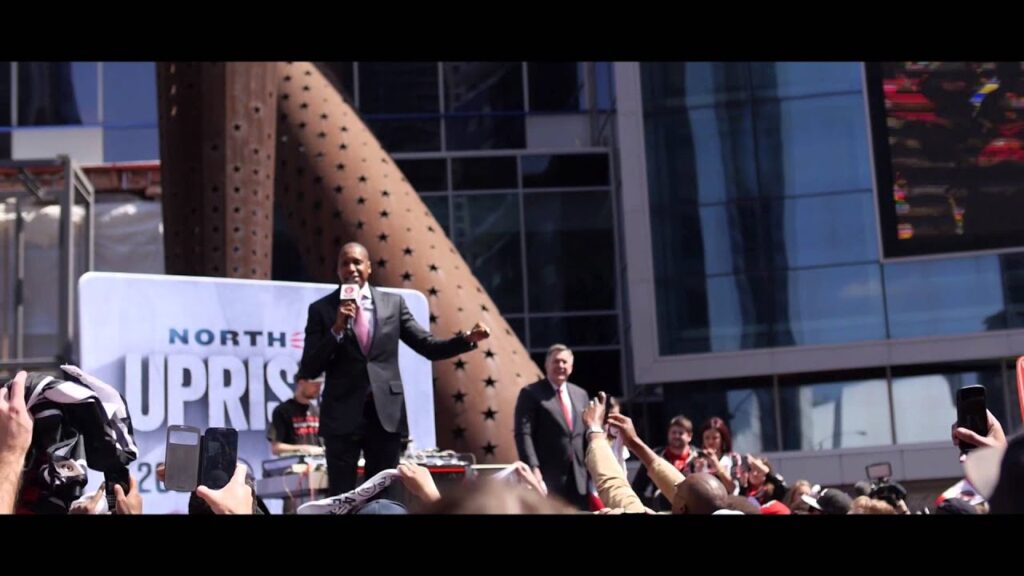 An image of former Toronto Raptors General Manager Masai Ujiri saying "F**k Brooklyn!" at a crowd gathering outside Scotiabank Arena in 2014. Sourced from Youtube channel 1:57 Pictures.